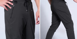 Front and back views of black men's jogger pants with zippered pockets and drawstring waistband.