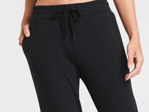 Close-up of black drawstring jogger pants with hand in pocket, casual wear