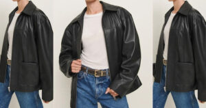 Front view of a person wearing a black leather jacket over a white t-shirt and blue jeans.
