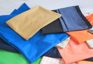 Stack of colorful cotton and polyester fabrics for sewing
