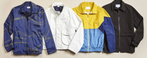 Four lightweight jackets in navy, white, yellow-blue, and black laid out on a flat surface.