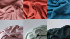 Six pieces of soft knit fabric in pastel and dark colors, arranged in a grid.