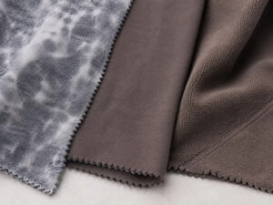 Assorted fabric swatches showcasing different textures, finishes, and materials for apparel and textile development.