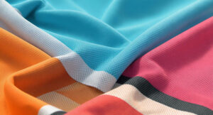 Close-up of colorful polyester and spandex fabric with equestrian pattern, smooth texture
