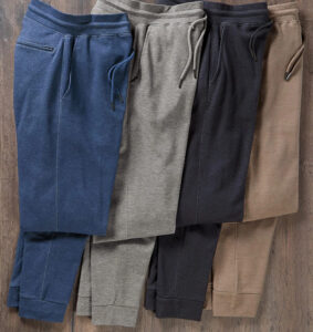 Four pairs of premium jogger sweatpants in neutral colors featuring drawstring waist and tapered fit.