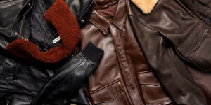 Assortment of premium leather jackets in black and brown tones, featuring shearling collars, quilted linings, and classic aviation-inspired designs displayed flat.