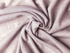 Close-up of soft tricot knit fabric twisted to showcase texture and stretch.