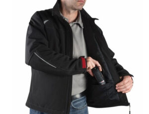 Man wearing a black tactical jacket with inner zippered pockets for carrying items.