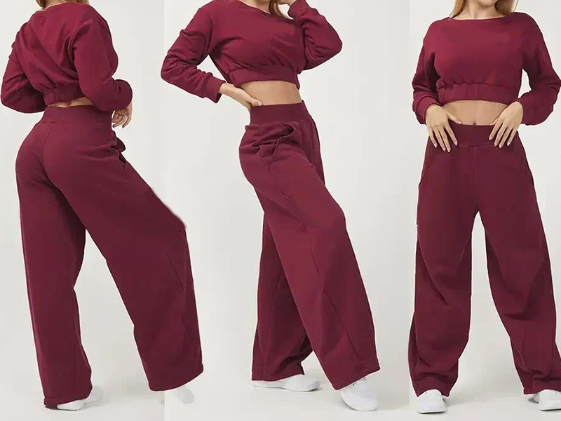 Woman modeling burgundy cropped sweatshirt and wide-leg sweatpants in casual athleisure outfit with relaxed comfortable streetwear style