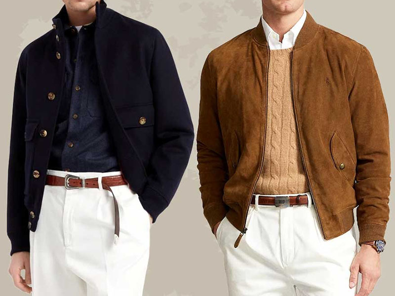 Two men wearing stylish bomber jackets; one in navy layered over a dark shirt with white pants, the other in brown suede bomber over a tan cable-knit sweater, showcasing casual smart fashion outfits