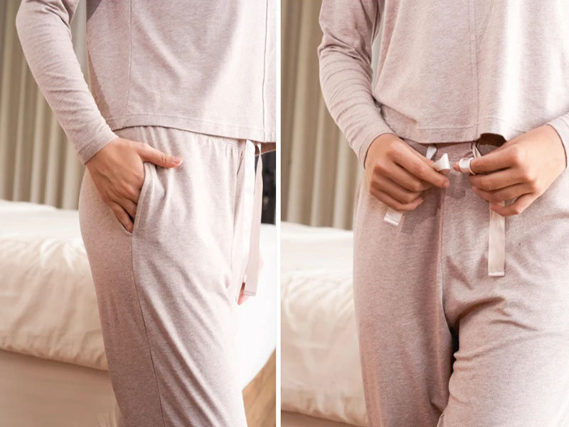 Close-up of women's lounge pants featuring side pockets and adjustable drawstring waistband, highlighting soft fabric, comfort, and relaxed sleepwear design.