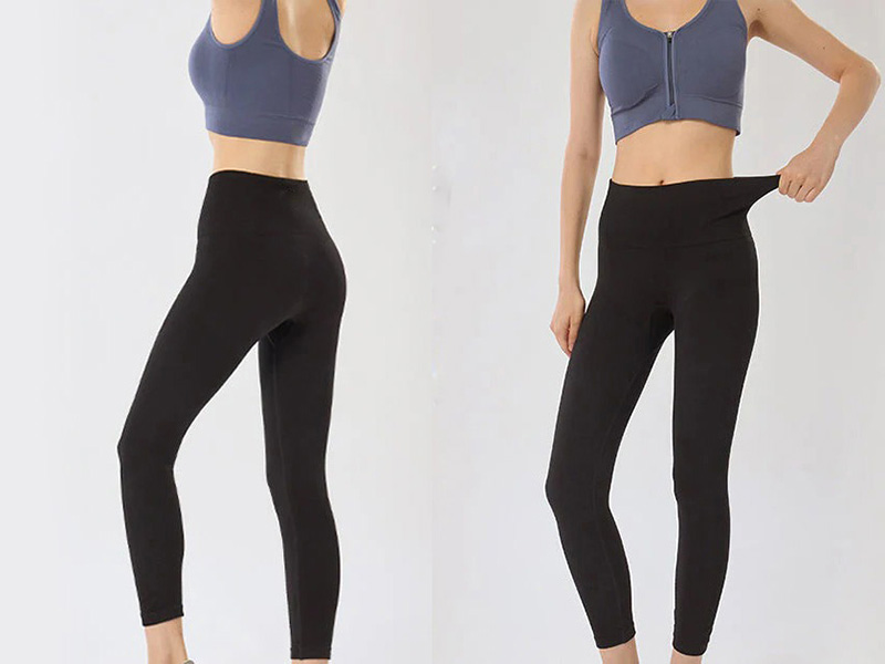 Stretchy black high-waist leggings worn by woman, demonstrating elasticity.