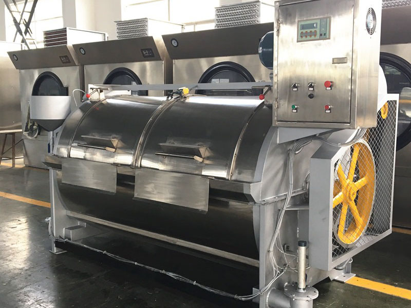 Large industrial washing machine used for stone or acid washing denim fabric in a factory
