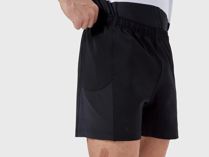 Close-up of black men's athletic shorts with elastic waistband and side pocket, designed for training, running, and everyday active comfort.