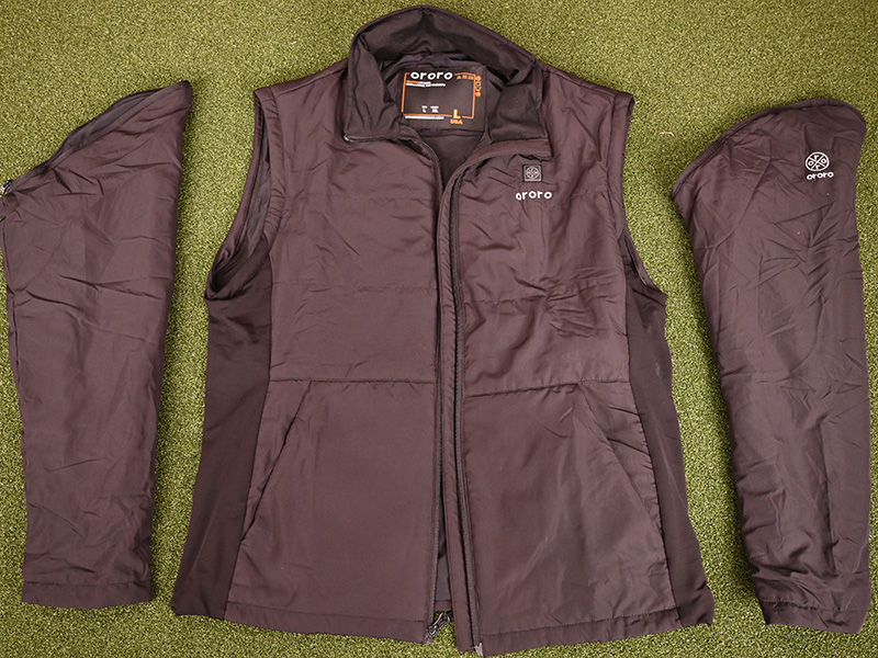 ORORO heated vest with detachable sleeves laid flat, showing zip-off arm sections on green surface.